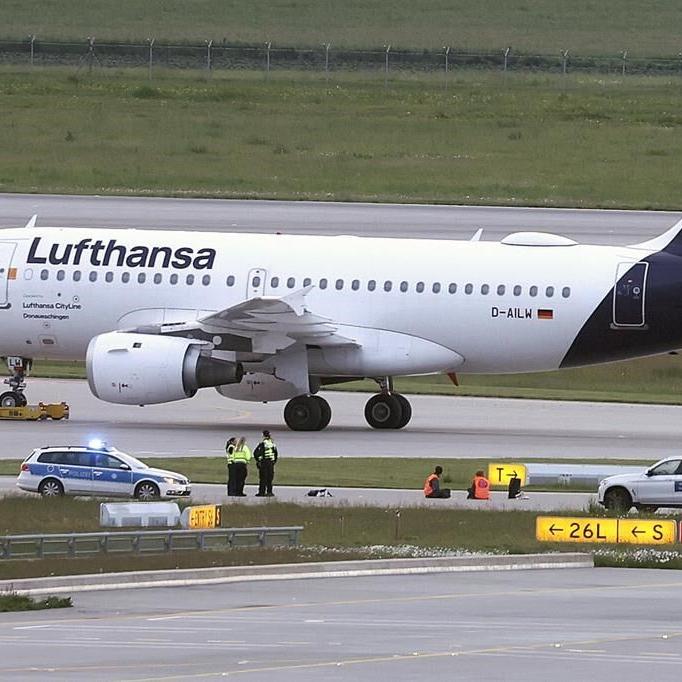 Climate activists glue themselves at Munich airport to protest pollution caused by flying